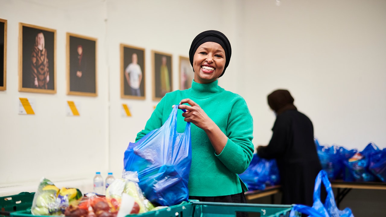 Woman packing food in food bank